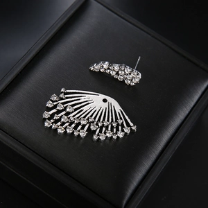 Silver fan-shaped asymmetric earring with rhinestones on a black jewelry box
