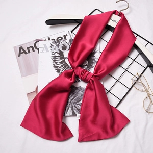 Elegant red 100% silk skinny scarf for women shown tied on a stylish fashion background