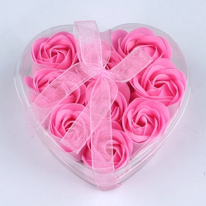 Detailed view of nine pink rose soap flowers in a clear heart-shaped gift box with a ribbon