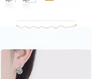 Macro detail of silver-tone hoop earrings with round brilliant-cut cubic zirconia stones