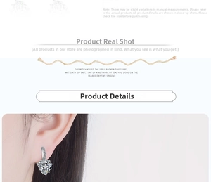 Close-up of elegant silver heart-shaped zircon drop earrings on a model ear lobe