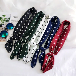 Detailed display of five colorful polka dot silk scarves in elegant row arrangement