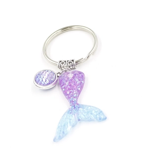 Detailed view of ocean mermaid tail keychain with blue and purple gradient scales