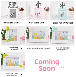 Detail of creative bear and violin photo frames in various pastel colors for desktop display