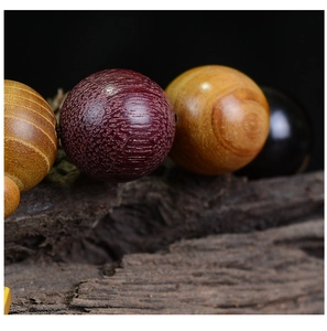 Macro shot of multi-colored wooden prayer beads showing natural grain and texture