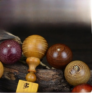 Detail of round wooden prayer beads on bark background featuring various redwood textures