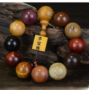 Close-up of mixed redwood prayer beads with various textures and a wooden name tag