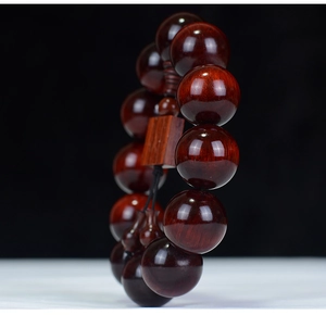 Detailed view of high-density red sandalwood prayer beads with natural wood grain texture