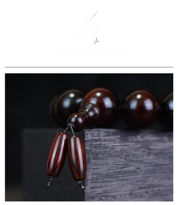 Macro detail of high-density red sandalwood beads with natural grain and smooth finish