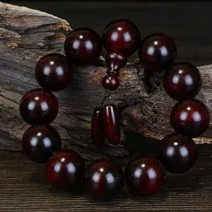 Authentic high density Small Leaf Red Sandalwood prayer beads on natural wood background
