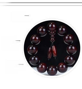 Macro detail of high-density red sandalwood beads with polished finish and natural grain