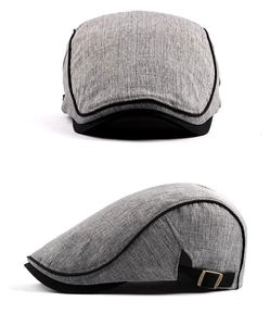 Detail view of grey linen beret hat with black brim and adjustable metal buckle