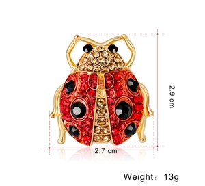 Detailed macro view showing the 2.7cm x 2.9cm size of the red ladybug crystal brooch
