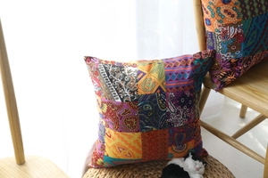 Detail of bohemian patchwork cushion covers with colorful ethnic patterns and tassels