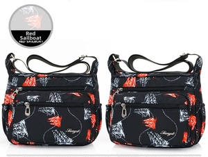 Detail of waterproof nylon crossbody bag featuring red and white sailboat patterns