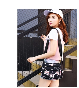 Detail shot of multi-pocket floral nylon crossbody bag with secure zipper compartments