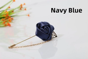 Detail of navy blue satin rose lapel pin with golden leaf and delicate chain link