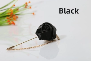 Detail of black satin rose brooch with gold chain and hollow leaf pin attachment