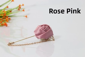 Detail of dusty rose satin fabric rose brooch with gold leaf and hanging chain