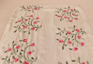 Close-up of elegant pink floral embroidery on cream chiffon silk sun protection scarf