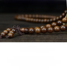 Macro shot of polished Jin si tan wood beads showing natural golden wood grain texture