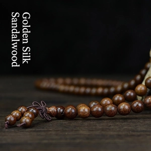 Premium Golden Silk Sandalwood 108 beads prayer bracelet with deep wood grain texture