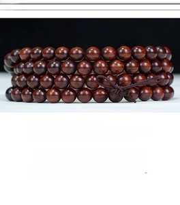 Macro detail of Zambia red sandalwood 108 prayer beads with fine polished texture