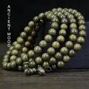 Bog Wood Buddhist beads bracelet in dark green featuring 108 polished natural wood beads