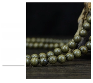 Macro shot of polished 108-bead ebony prayer bracelet with natural wood textures