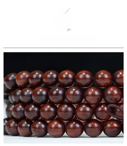 Macro shot of 108 high-density sandalwood beads with natural texture and polished finish