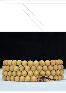 Macro detail of natural wood beads with visible growth rings and handcrafted knots