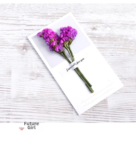 Detail of purple dried flowers on Especially For You greeting card with white wood background