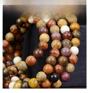Macro shot of 108 multi-grain wooden prayer beads showing various natural textures and colors