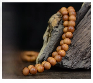 Close-up of Indonesian sandalwood 108 prayer beads with natural wood grain texture