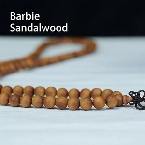 Barbie sandalwood 108 Buddhist prayer beads with brown Chinese knot on dark background