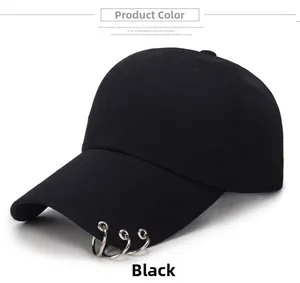 Detail of black cotton baseball cap featuring three silver metal rings on the brim