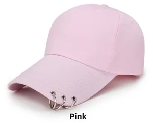 Detailed shot of pink cotton baseball cap featuring three silver metal rings on the brim