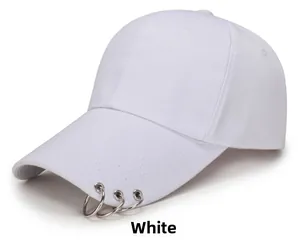 Detail of white cotton baseball cap featuring three silver metal rings on the brim