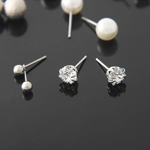 Elegant silver earring set featuring geometric pearls, CZ diamonds, and metal bead studs