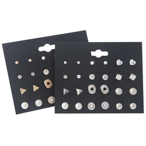 Detailed set of varied metal stud earrings with pearls and crystals on display cards