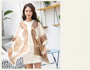 Close-up of lightweight off-white chiffon shawl with vintage brown paisley floral prints