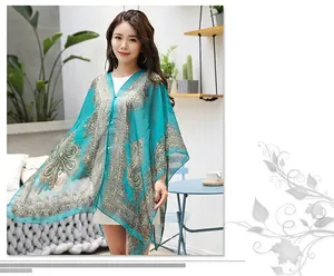 Detail of lake blue paisley chiffon shawl with delicate pearl button closure