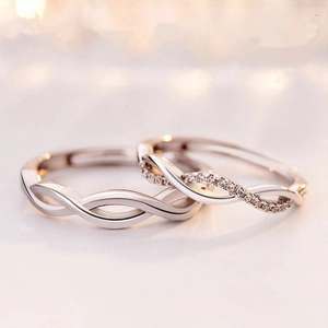 Minimalist silver couple rings featuring wavy twisted bands and sparkling cubic zirconia