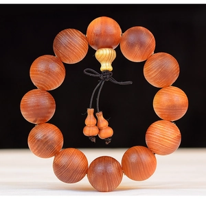 Close-up of translucent Blood Dragon Wood prayer beads with natural grain and gourd charms