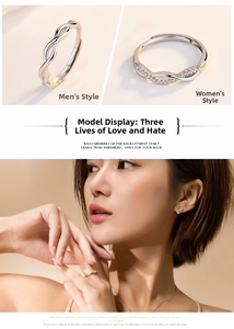 Detail of silver plum blossom couple rings featuring zircon inlay and mobius design