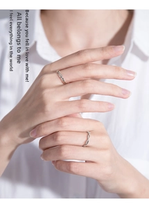 Detail of interlocking infinity couple rings on hands for a romantic gift presentation