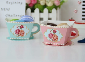 Detailed view of mint green and pink European style teapot paper gift boxes for candy