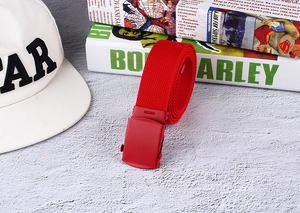 Detail view of a red nylon canvas belt featuring a matching red matte alloy buckle