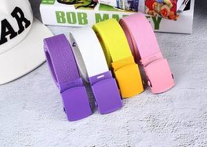 Detail view of colorful nylon canvas belts with matte automatic buckles in four colors