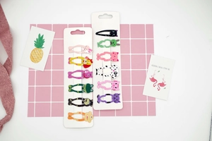 Detailed set of twelve colorful animal-shaped metal hair clips on display cards